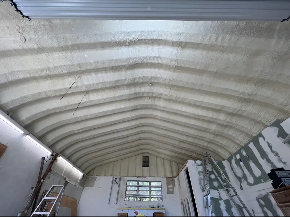 Spray polyurethane foam applied to the underside of a metal roof deck in Schuyler